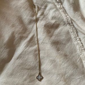 Gold necklace with white shiny charm with nice clasp from a small local boutique